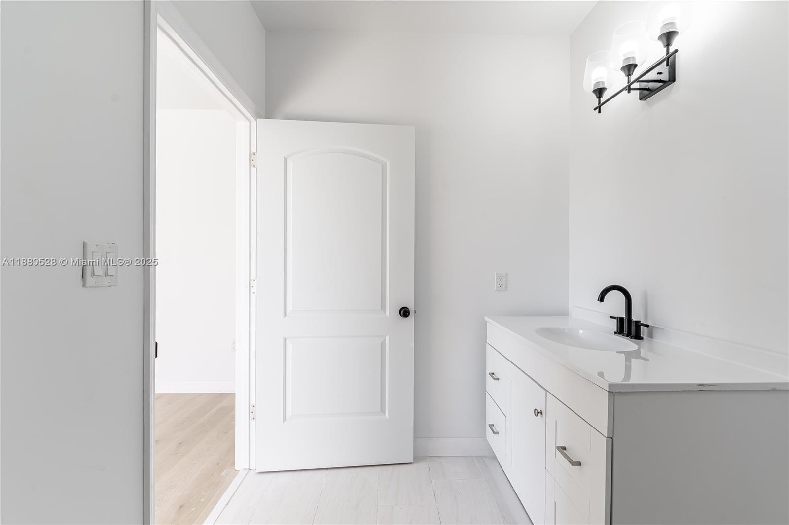 2575 Southwest 64th Avenue, Unit 7 Miramar, FL 33023 - Photo 8 of 13 a bathroom with a double vanity sink and mirror