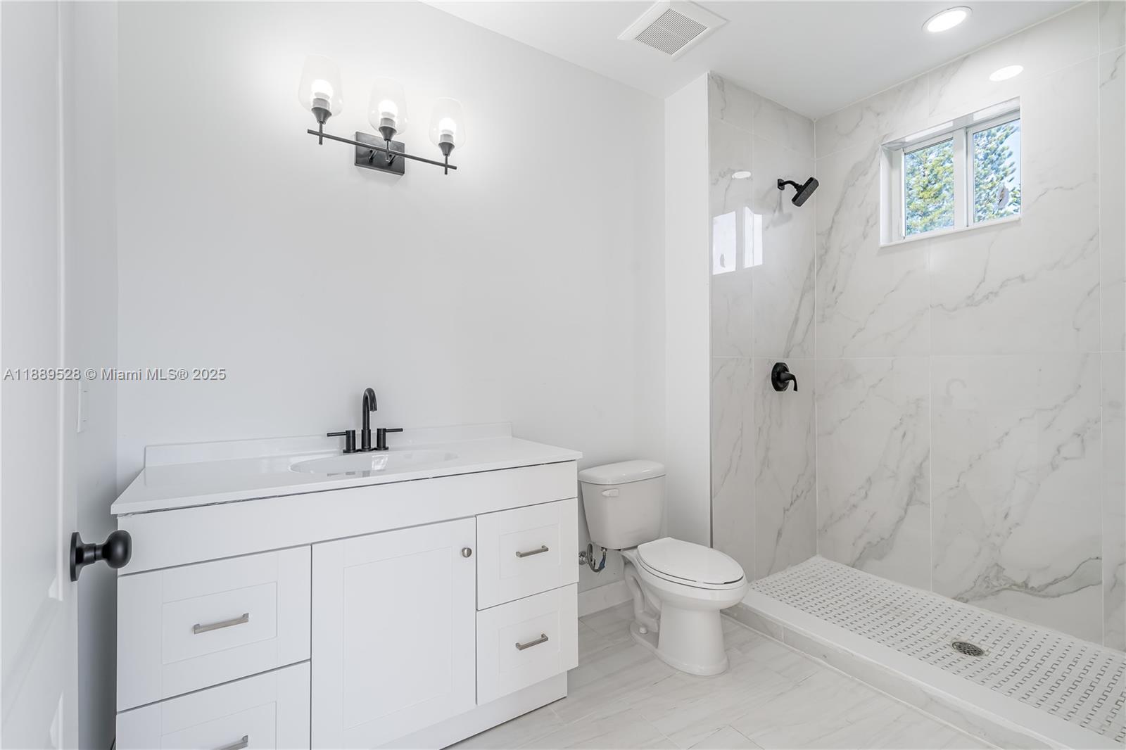 2575 Southwest 64th Avenue, Unit 7 Miramar, FL 33023 - Photo 10 of 13 a bathroom with a sink a toilet and shower
