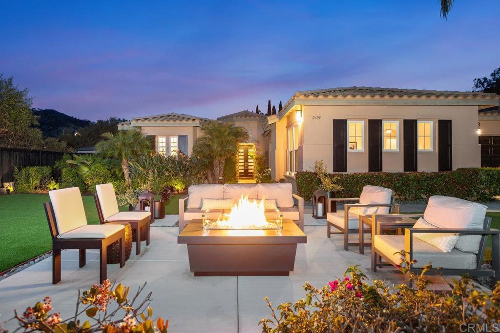 a view of a patio with couches table and chairs and potted plants