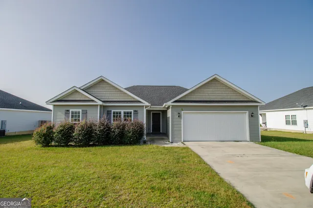 a front view of a house with garden