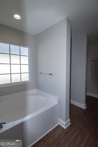 a white bath tub sitting next to a window