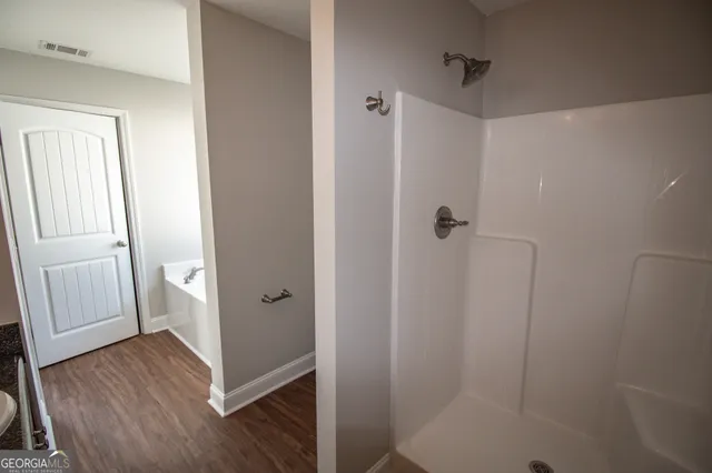 a bathroom with a shower and toilet