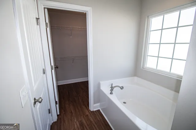 a bathroom with a bathtub and a window