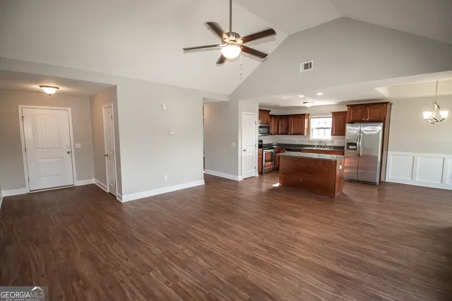a view of kitchen with sink microwave and wooden floor