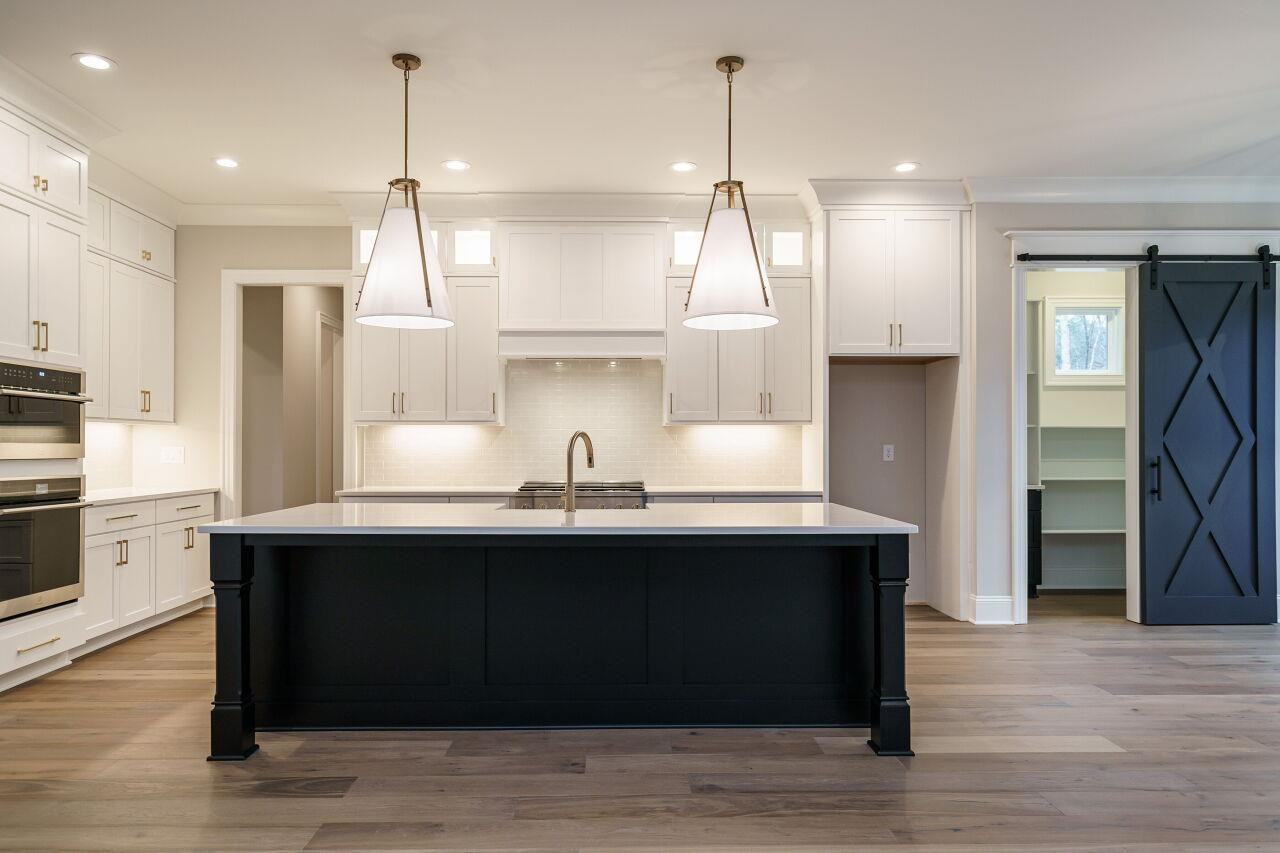2125 Gardenbrook Drive Raleigh, NC 27606 - Photo 12 of 35 a kitchen with stainless steel appliances granite countertop a sink a refrigerator a stove and a wooden floors