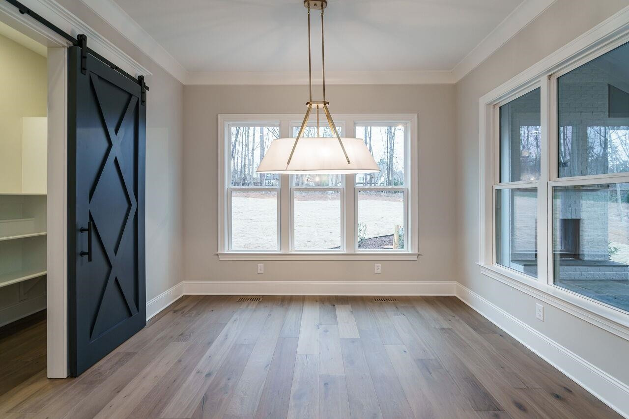 2125 Gardenbrook Drive Raleigh, NC 27606 - Photo 16 of 35 an empty room with wooden floor and windows
