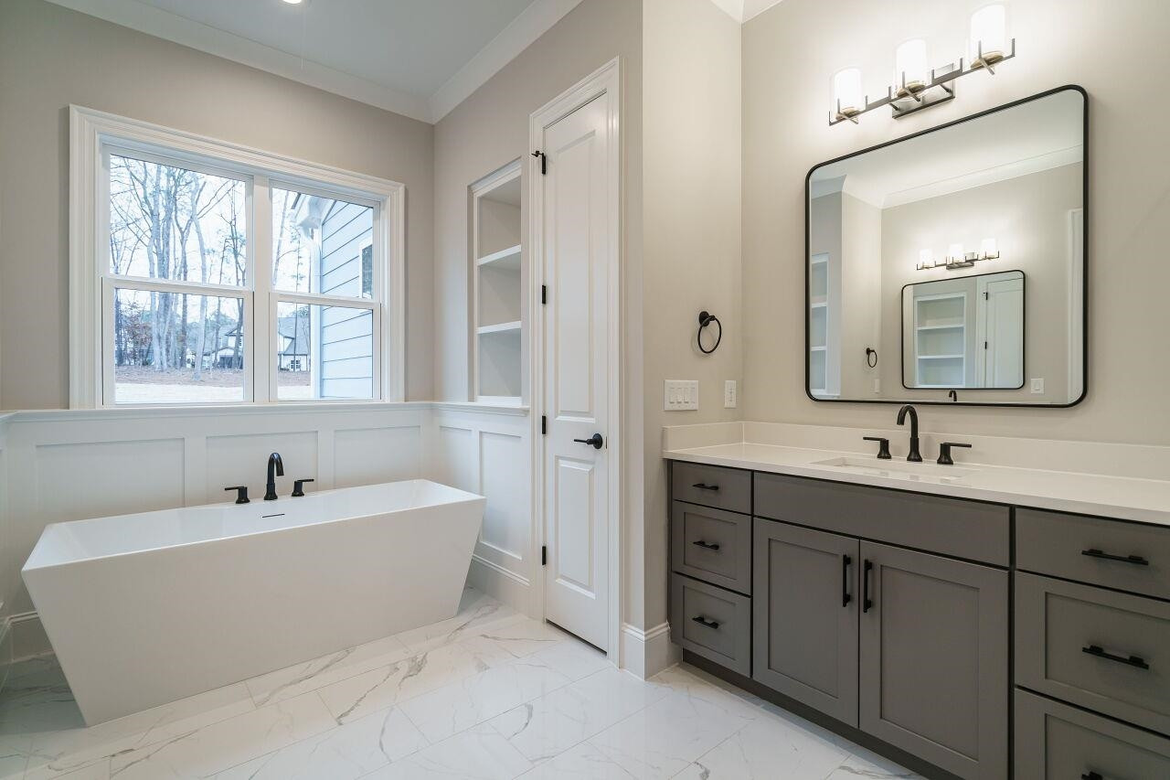2125 Gardenbrook Drive Raleigh, NC 27606 - Photo 18 of 35 a bathroom with a double vanity sink bathtub and mirror