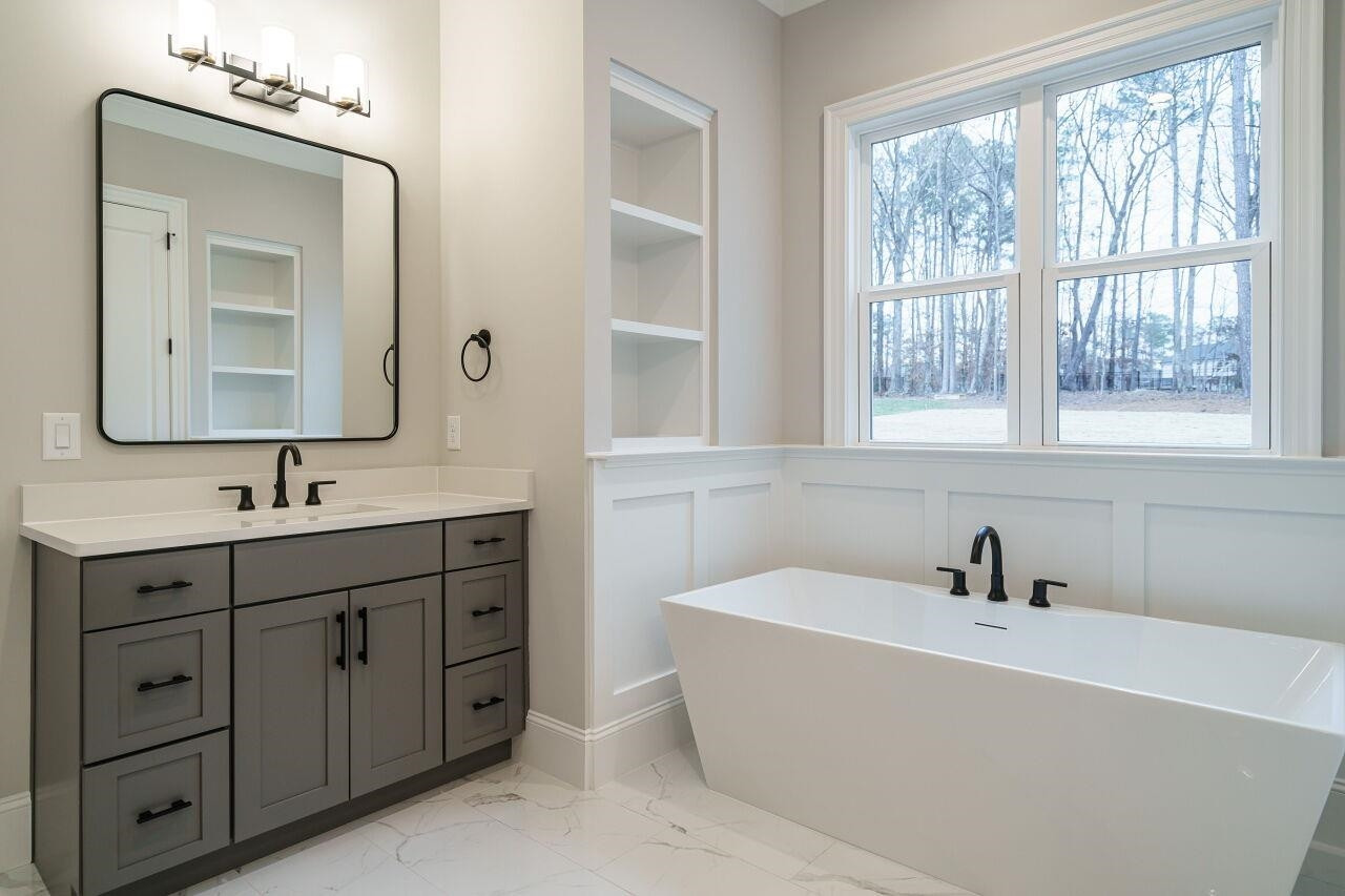2125 Gardenbrook Drive Raleigh, NC 27606 - Photo 19 of 35 a bathroom with a tub sink and mirror