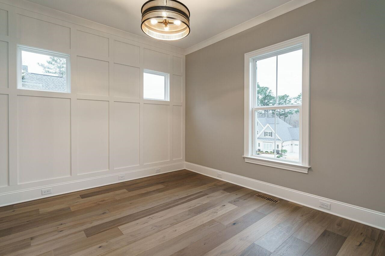 2125 Gardenbrook Drive Raleigh, NC 27606 - Photo 22 of 35 an empty room with wooden floor and windows