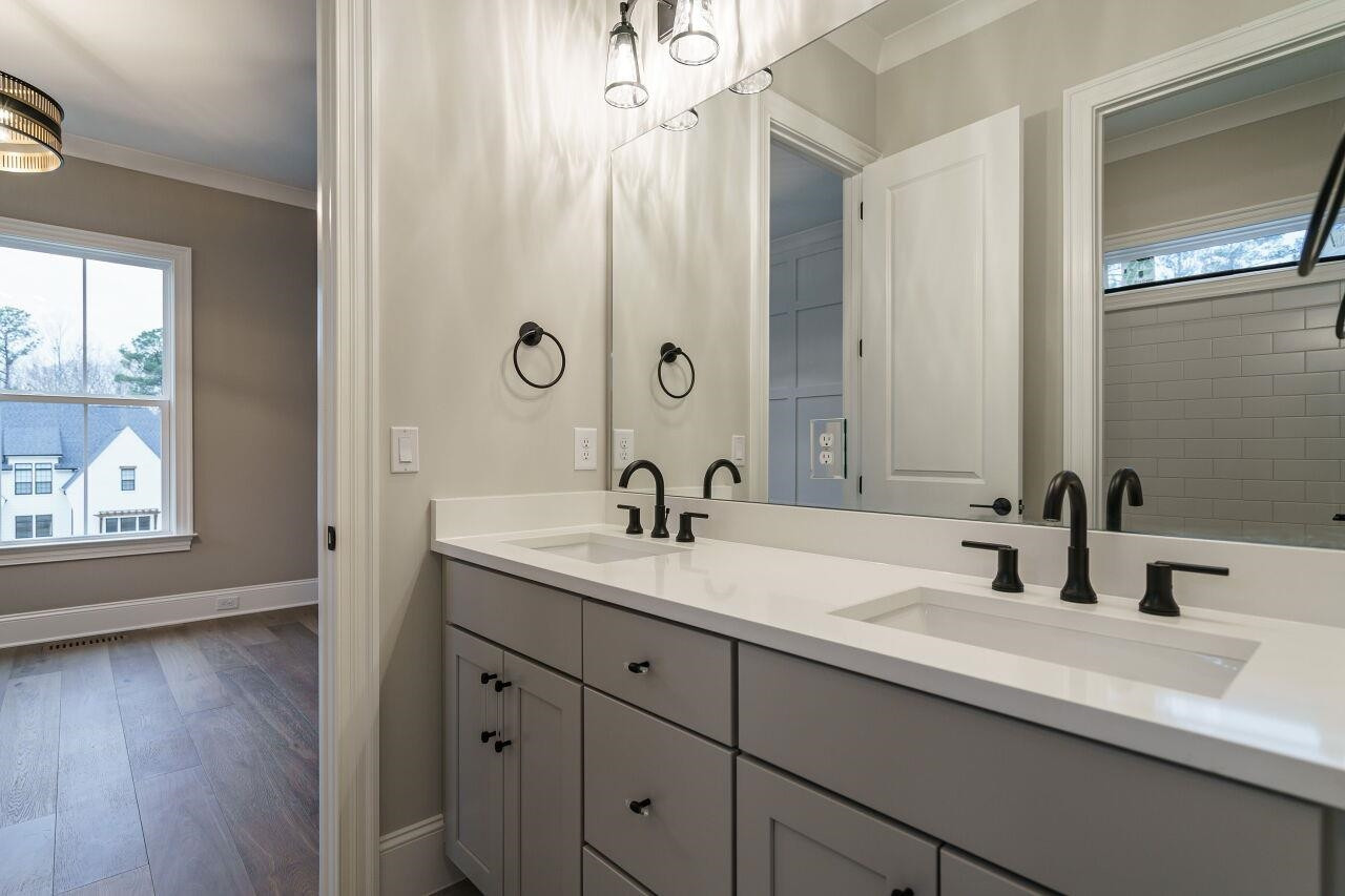 2125 Gardenbrook Drive Raleigh, NC 27606 - Photo 23 of 35 a bathroom with a double vanity sink and a mirror