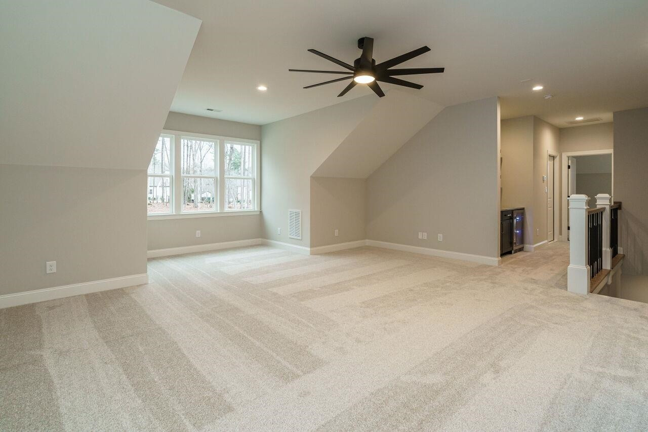 2125 Gardenbrook Drive Raleigh, NC 27606 - Photo 31 of 35 an empty room with ceiling fan and windows