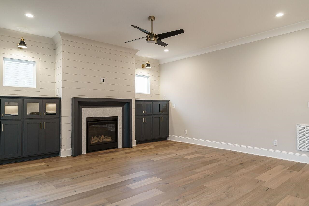 2125 Gardenbrook Drive Raleigh, NC 27606 - Photo 9 of 35 an empty room with windows and a ceiling fan