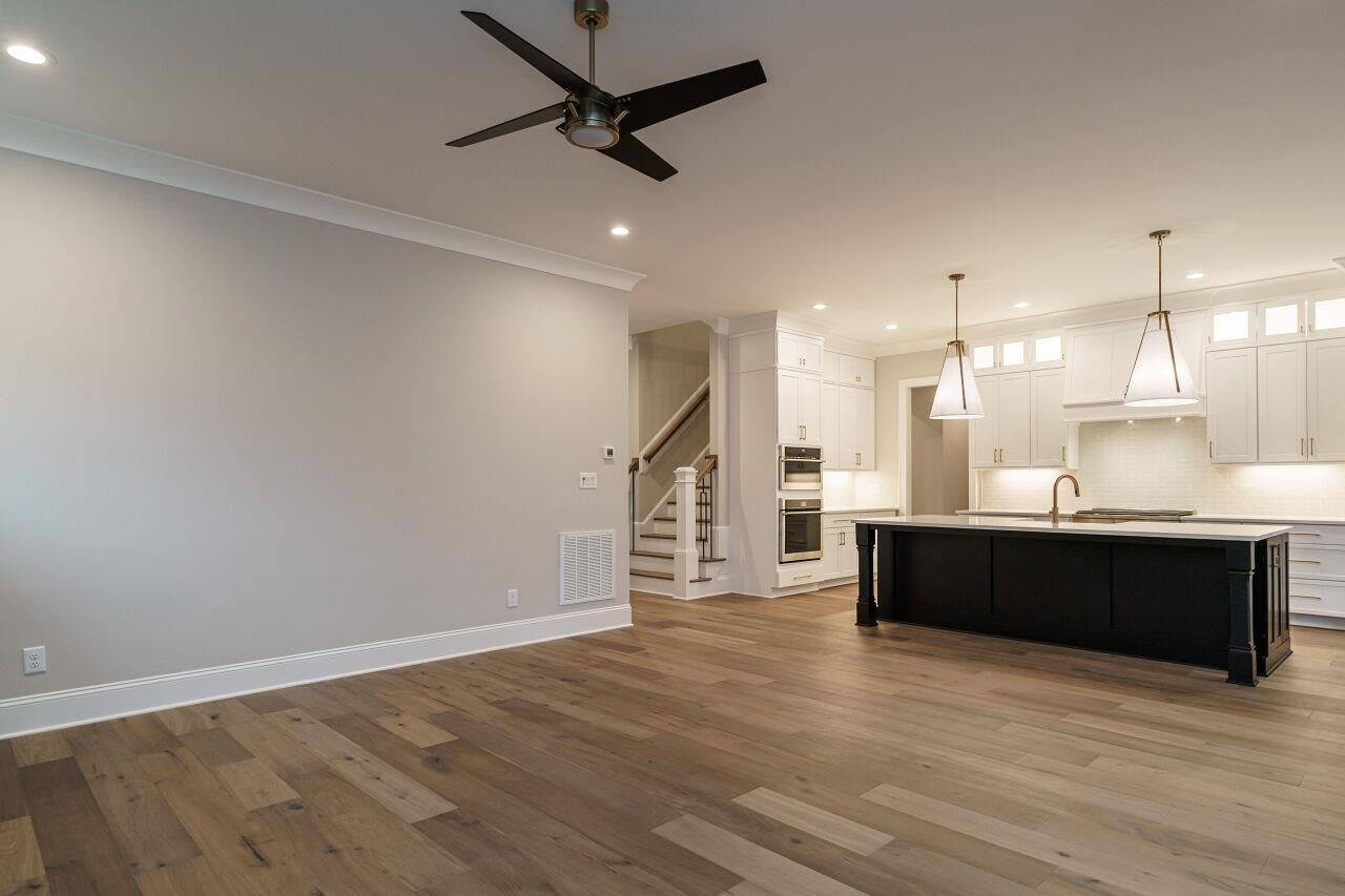 2125 Gardenbrook Drive Raleigh, NC 27606 - Photo 10 of 35 a living room with stainless steel appliances kitchen island granite countertop furniture and a wooden floor