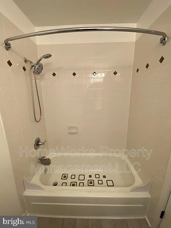 10547 Twin Rivers Road, Unit F2 Columbia, MD 21044 - Photo 2 of 2 a bathroom with a bath tub