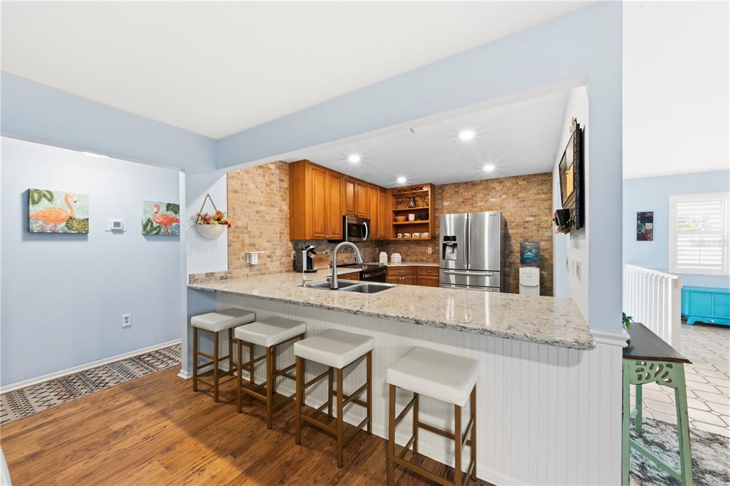 417 Poinsettia Road Anna Maria, FL 34216 - Photo 11 of 34 a view of a kitchen with kitchen island a large window a sink and counter space