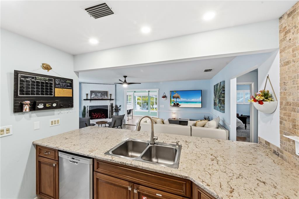 417 Poinsettia Road Anna Maria, FL 34216 - Photo 14 of 34 a kitchen with furniture a flat screen tv and kitchen view