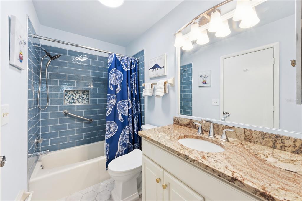 417 Poinsettia Road Anna Maria, FL 34216 - Photo 19 of 34 a bathroom with a granite countertop sink a toilet and bathtub