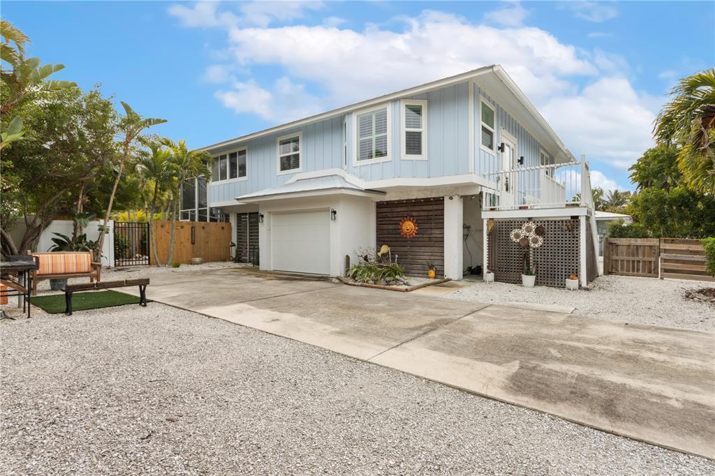 417 Poinsettia Road Anna Maria, FL 34216 - Photo 2 of 34 a view of a white house with a outdoor space