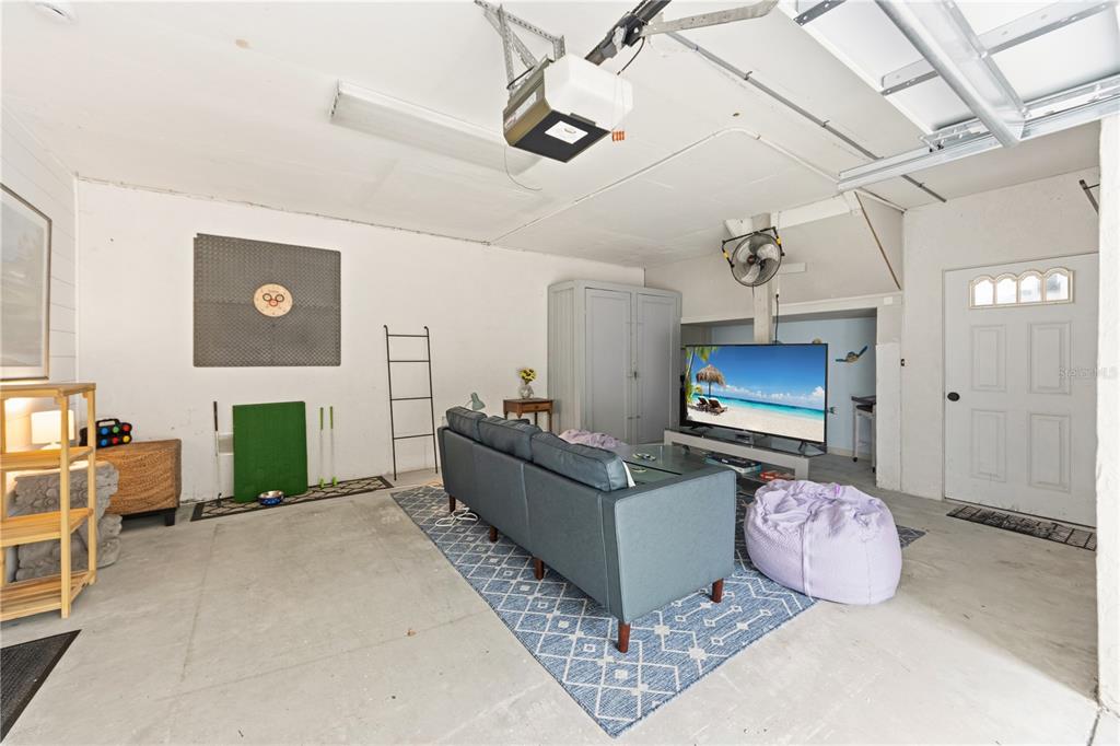 417 Poinsettia Road Anna Maria, FL 34216 - Photo 22 of 34 a living room with furniture and a flat screen tv