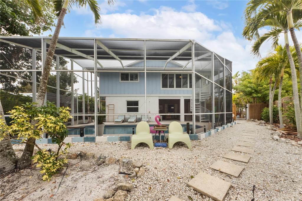 417 Poinsettia Road Anna Maria, FL 34216 - Photo 28 of 34 a view of a chair and table in backyard