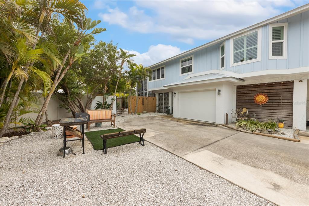417 Poinsettia Road Anna Maria, FL 34216 - Photo 3 of 34 a view of backyard of house with outdoor seating