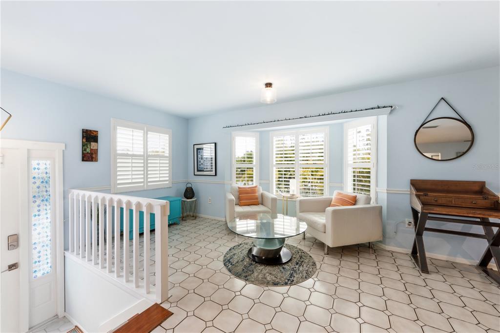 417 Poinsettia Road Anna Maria, FL 34216 - Photo 7 of 34 a living room with furniture and a floor to ceiling window