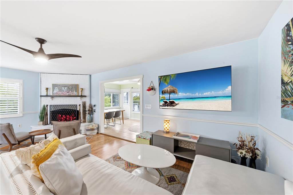 417 Poinsettia Road Anna Maria, FL 34216 - Photo 9 of 34 a living room with furniture a fireplace and a flat screen tv