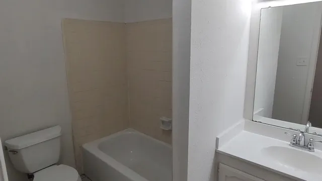 a bathroom with a sink toilet and bathtub
