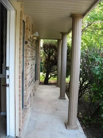 a view of a room with a large window and front door