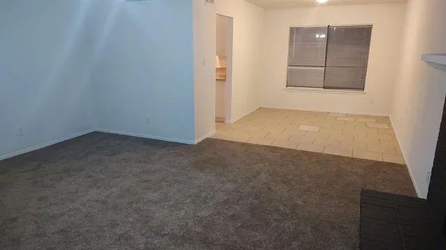 an empty room with a empty space and window