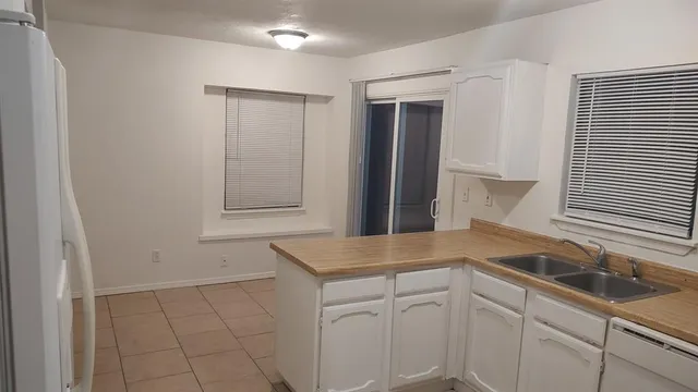 a kitchen with a sink and cabinets
