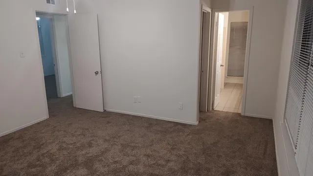 a view of an empty room with closet area