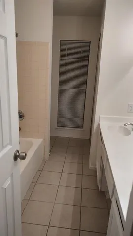 a bathroom with a sink a vanity and tub