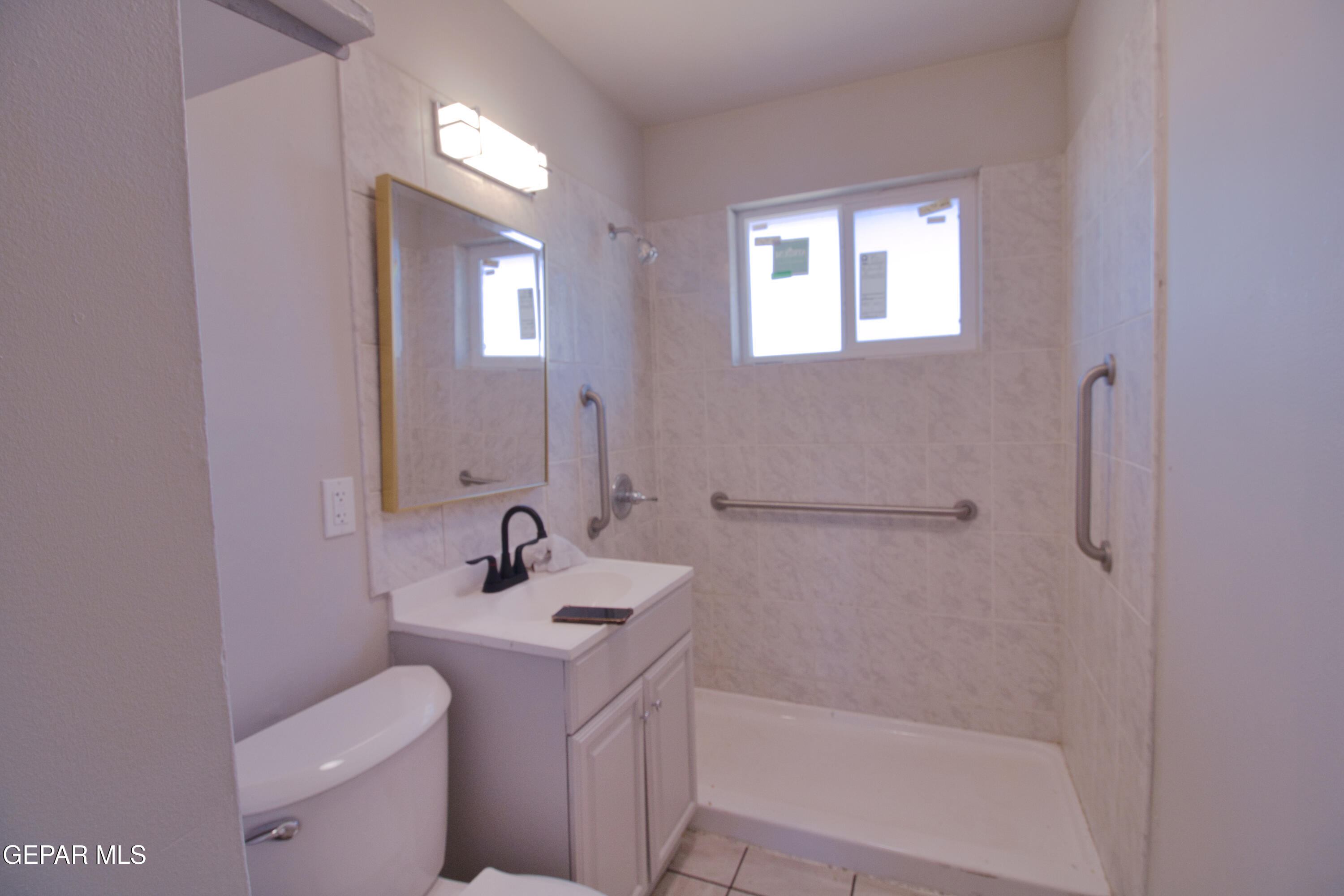 9104 Raleigh Drive El Paso, TX 79924 - Photo 12 of 20 a bathroom with a sink a toilet and shower