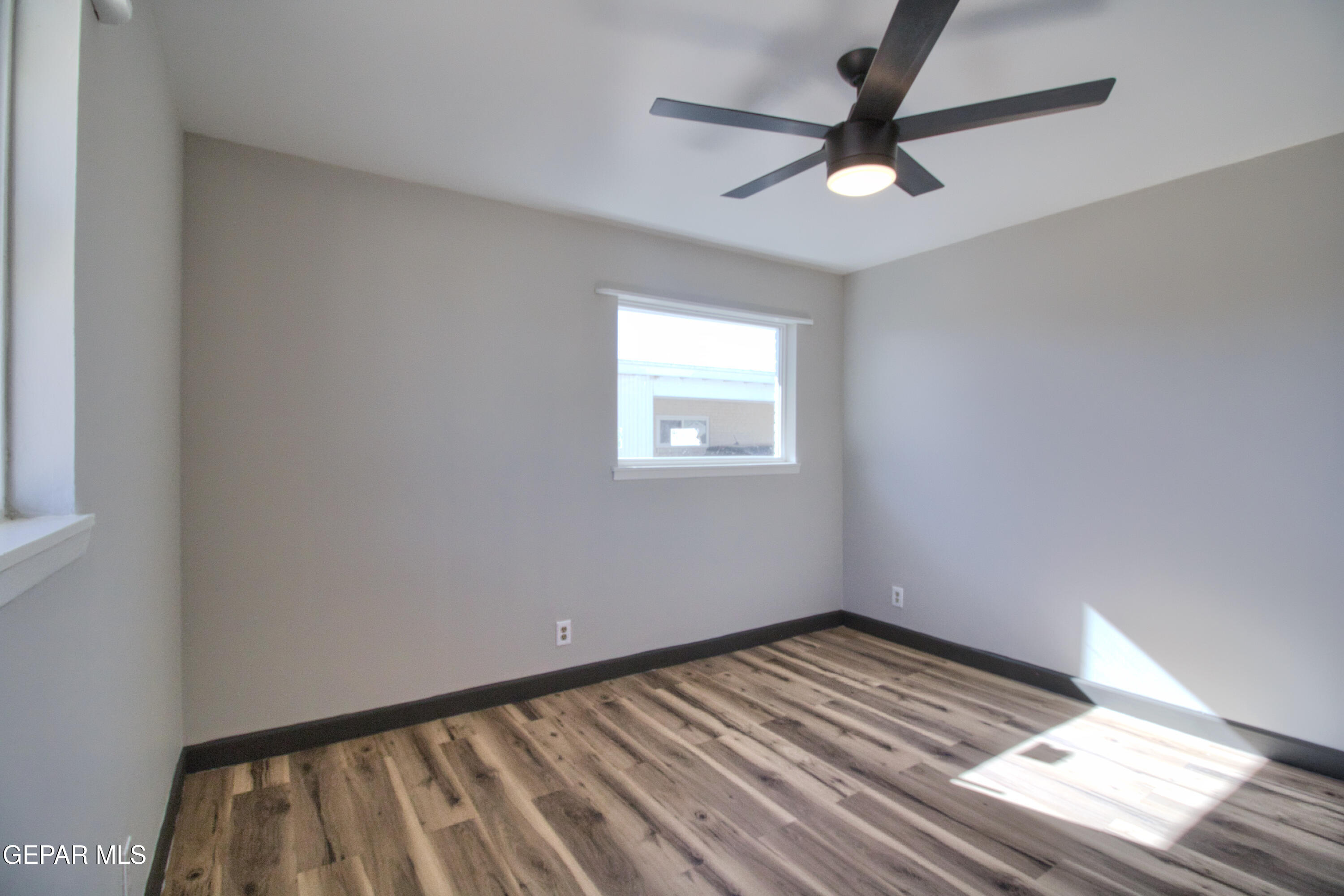 9104 Raleigh Drive El Paso, TX 79924 - Photo 13 of 20 wooden floor in an empty room with a window