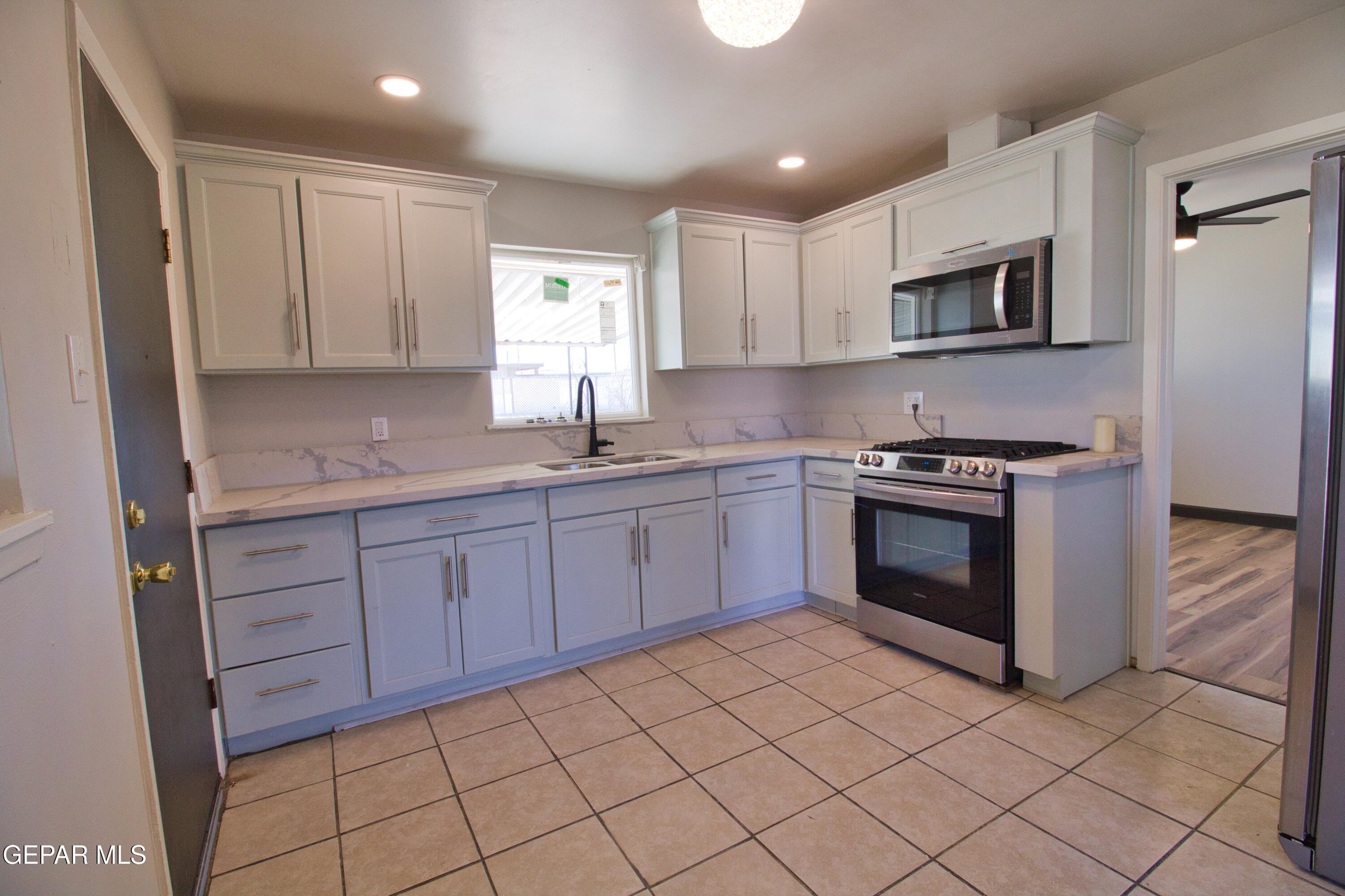 9104 Raleigh Drive El Paso, TX 79924 - Photo 14 of 20 a kitchen with stainless steel appliances granite countertop a sink and a stove