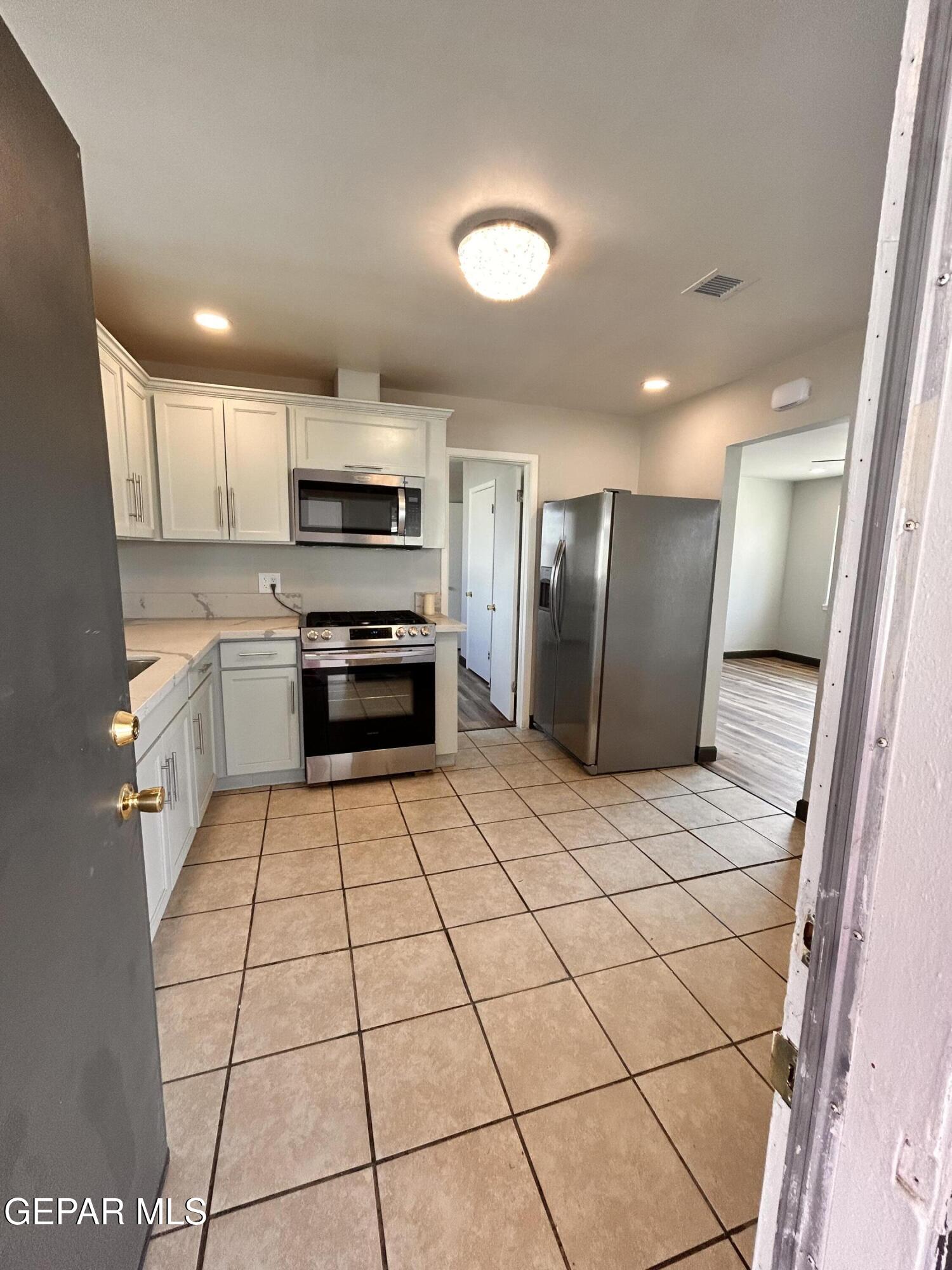 9104 Raleigh Drive El Paso, TX 79924 - Photo 15 of 20 a kitchen with stainless steel appliances a refrigerator sink and microwave