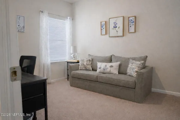 a bed room with a bed and a chair
