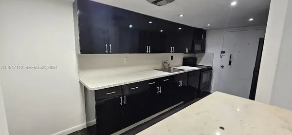 a kitchen with a sink and cabinets