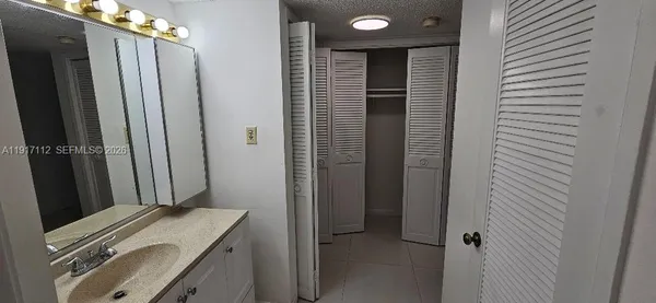 a living room with stainless steel appliances kitchen island a table and chairs in it
