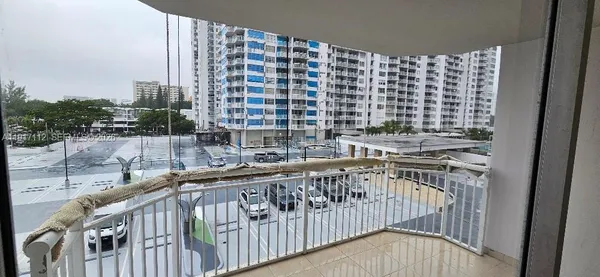 a large room with lots of white furniture and couches