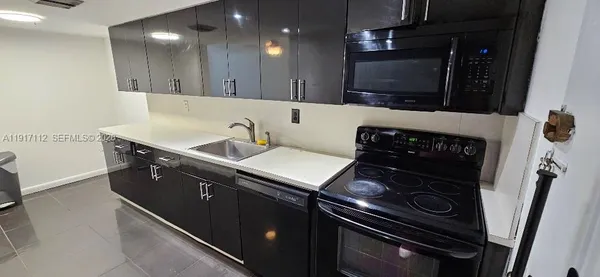 a kitchen with a sink stove and microwave