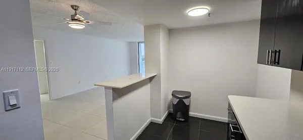 a bathroom with a granite countertop sink a toilet and a mirror