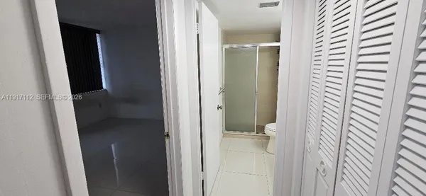 a view of sign board with flower plants and wooden fence