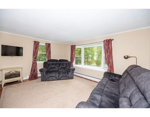 88 Beachview Road Lunenburg, MA 01462 - Photo 5 of 17 a living room with furniture a flat screen tv and a large window