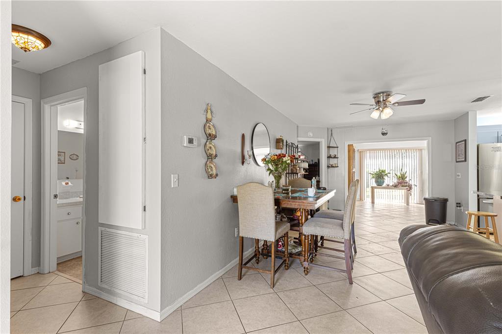 8475 Southeast 137th Loop Summerfield, FL 34491 - Photo 14 of 75 a living room with furniture and a dining table