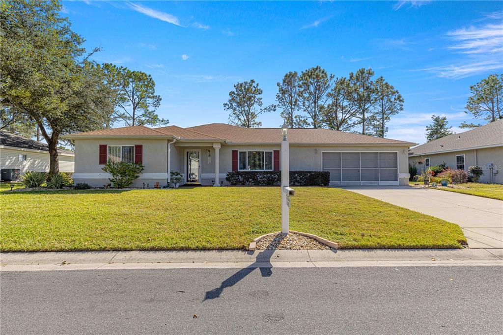 8475 Southeast 137th Loop Summerfield, FL 34491 - Photo 2 of 75 a house with swimming pool in front of it