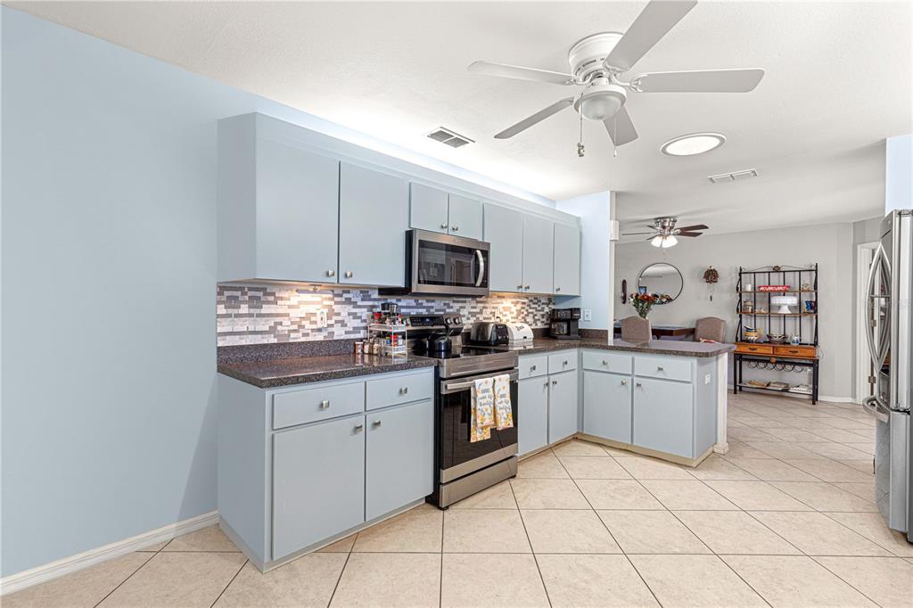 8475 Southeast 137th Loop Summerfield, FL 34491 - Photo 23 of 75 a kitchen with granite countertop appliances cabinets and a sink