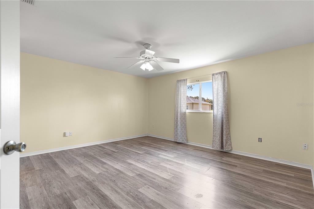 8475 Southeast 137th Loop Summerfield, FL 34491 - Photo 25 of 75 wooden floor in an empty room with a window