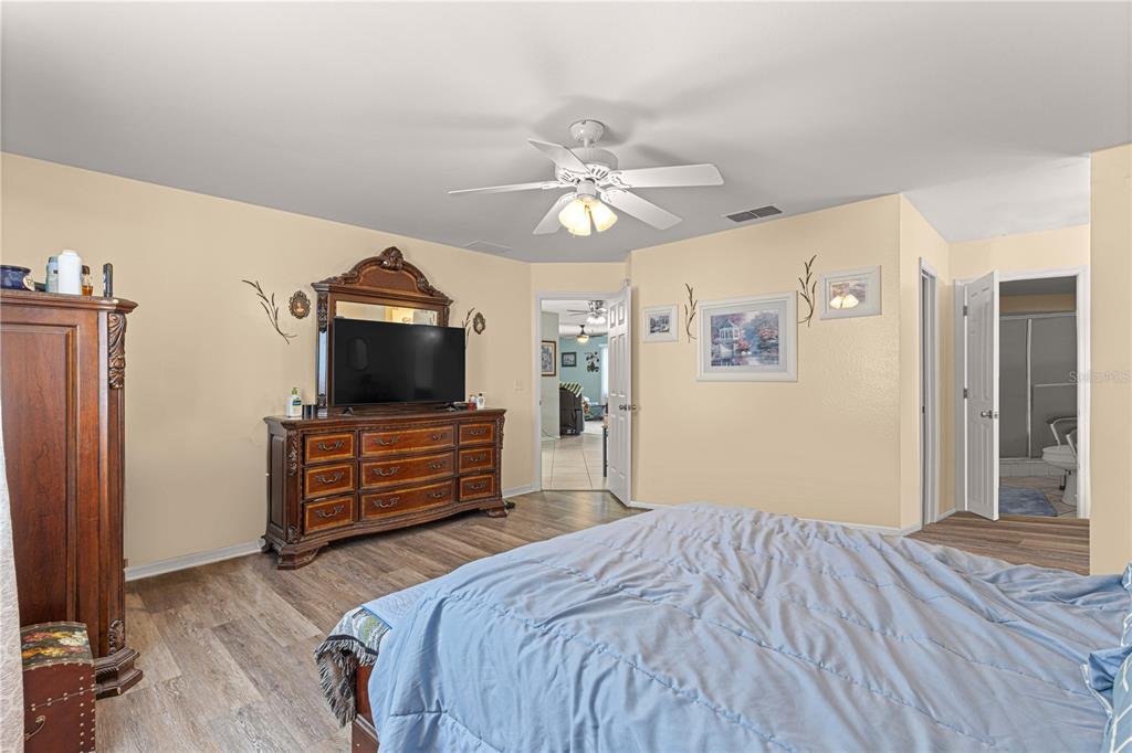 8475 Southeast 137th Loop Summerfield, FL 34491 - Photo 27 of 75 a bedroom with a bed and a flat screen tv